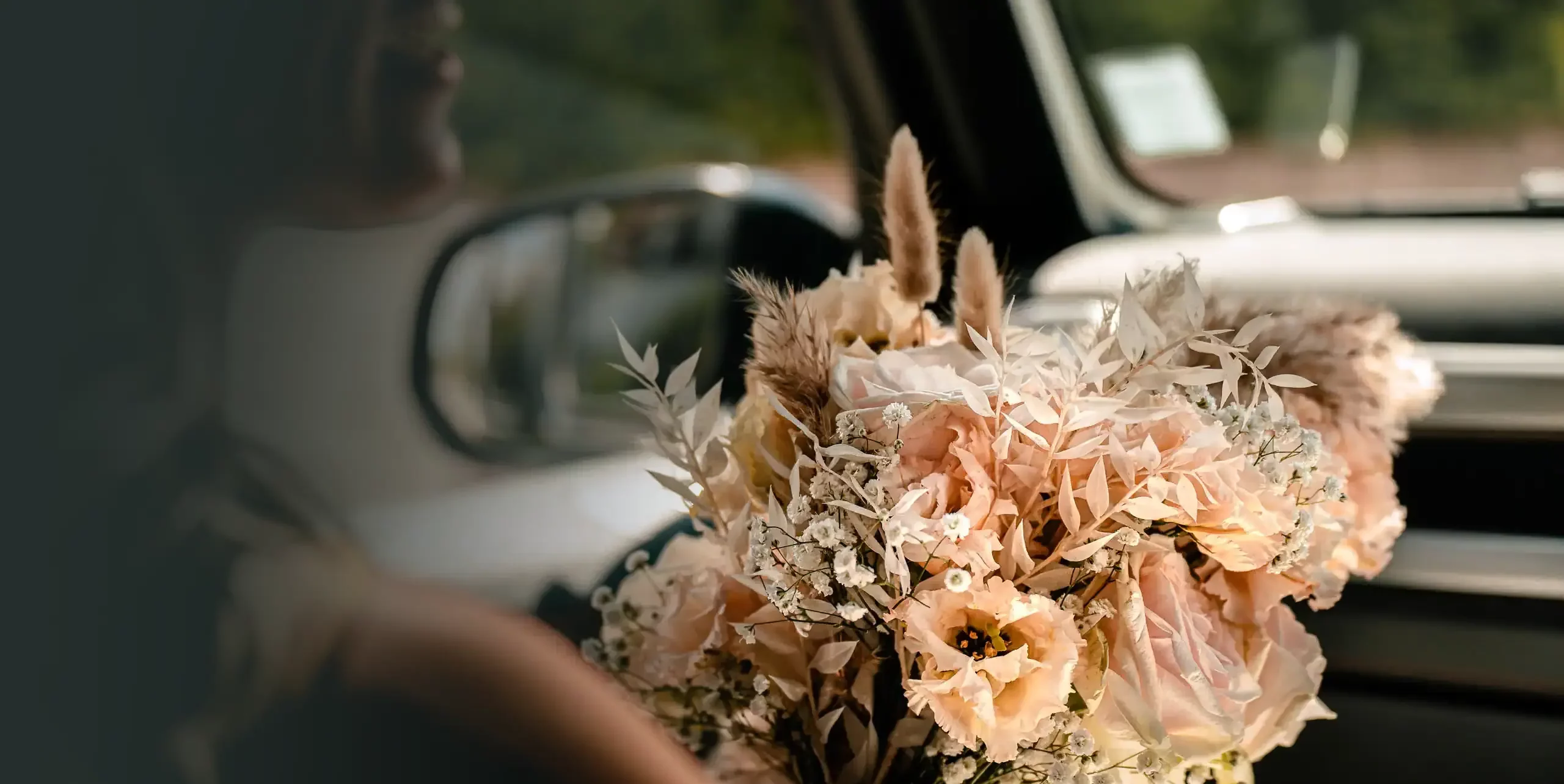 photo mariage d'une mariée tenant son bouquet dans sa voiture